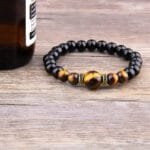 Pulsera de piedras naturales y botella de cerveza, estilo moderno